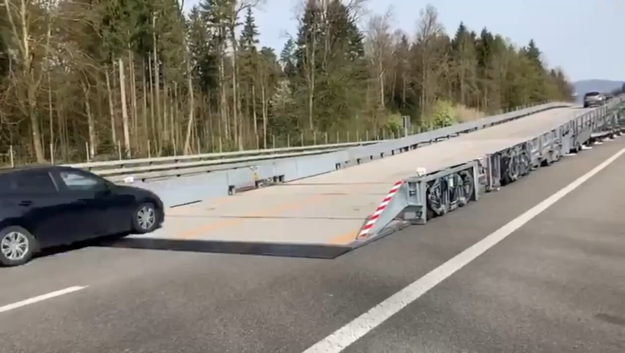 Switzerland uses a mobile overpass bridge to carry out road work without stopping traffic.