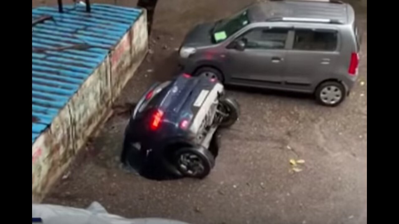 Parked car in India swallowed by sinkhole after Rain