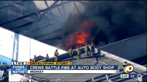 Crews battle fire at auto body shop