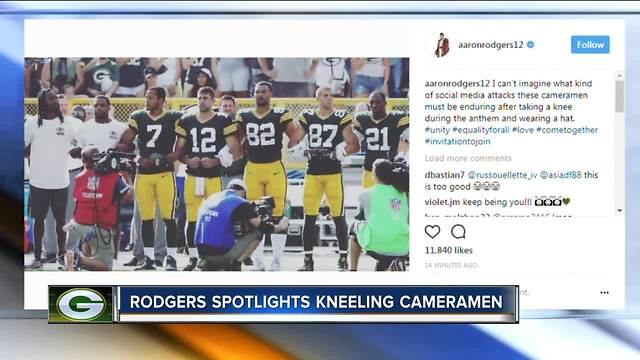 Rodgers jokes: Cameramen take knee during anthem