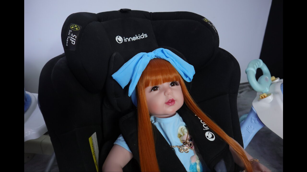 Toy doll filming car seat video