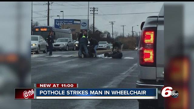 Man in mechanical wheelchair hits pothole