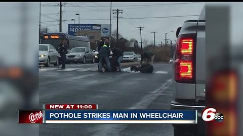 Man in mechanical wheelchair hits pothole