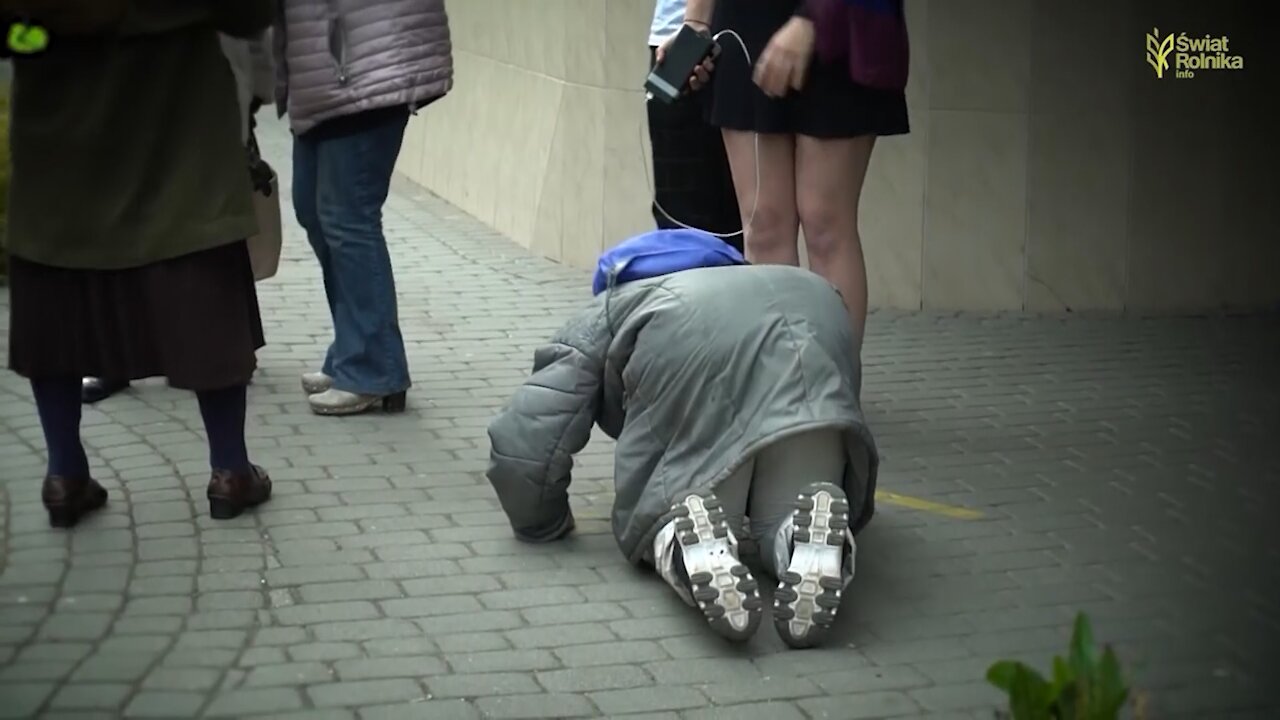 Elderly woman in tears kisses feet of angry LGBT activist, then they make sign of Cross together