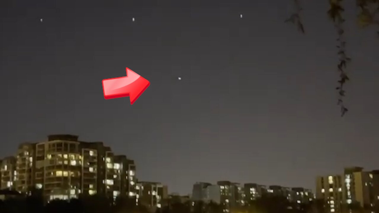 White UFO over a building at night [Space]