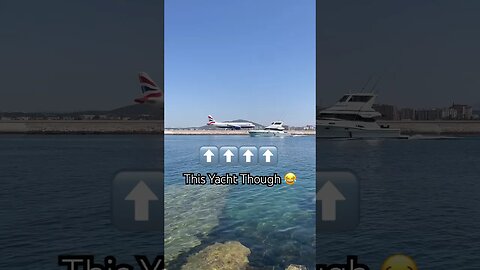 A Beautiful Yacht Passes British Airways Plane as it Prepares for Departure