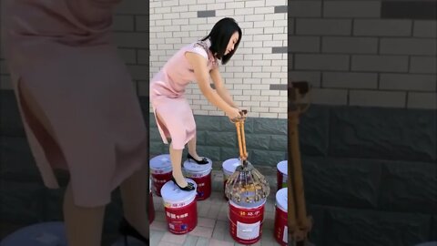 Pretty Chinese Girl Works Hard To Lock Down Barrel Lids