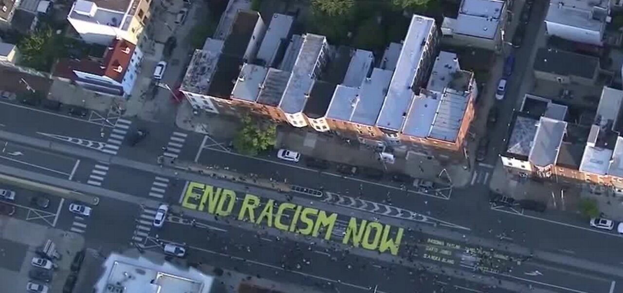 Protesters paint 'end racism now'