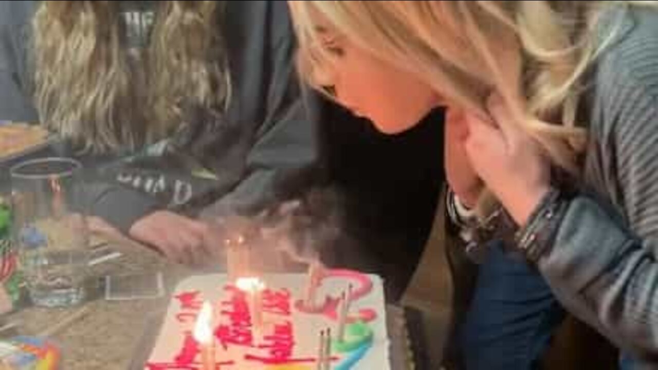 Girl has trouble blowing out birthday candles