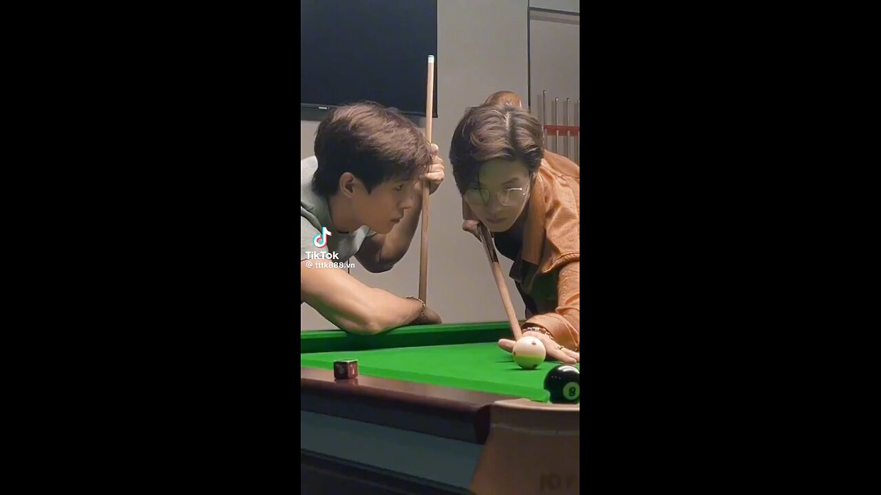 2 handsome guys playing billiards