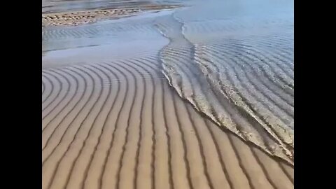 Waves rippling over sand