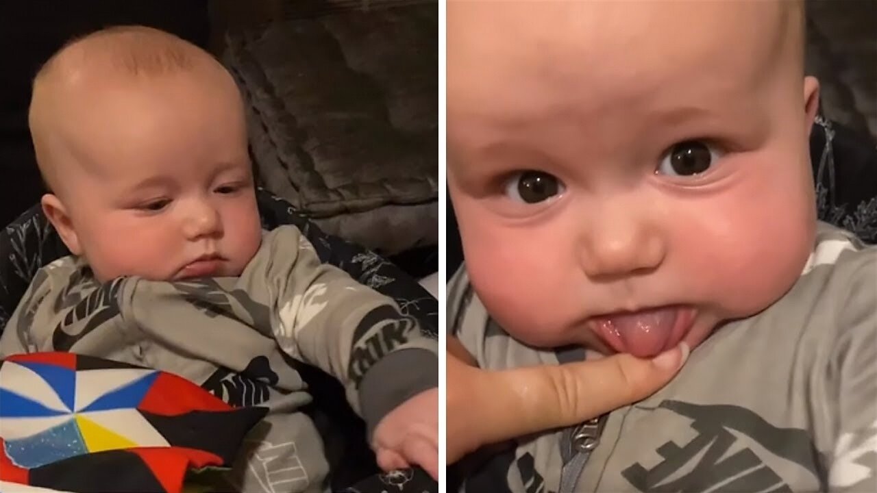 Baby adorably blocks mommy from showing his teeth