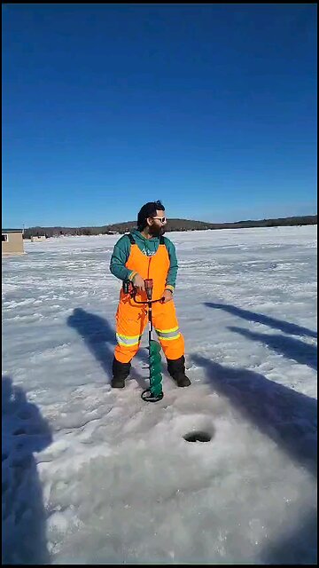 Drilling hole on ice for fishing