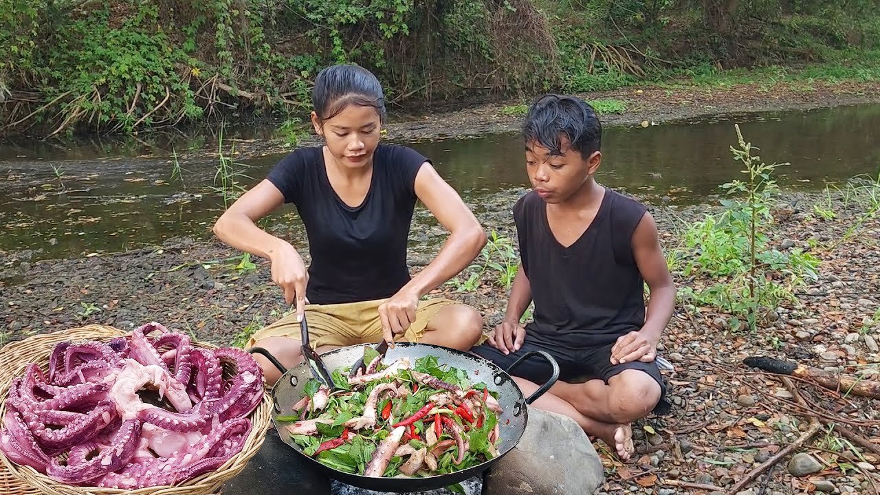 Yummy cook Octopus arm with hot chili for dinner, Survival cooking in forest