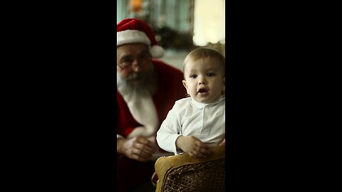 A small kid playing with santa