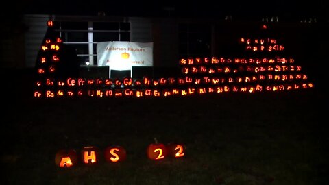 Students carve a pumpkin periodic table