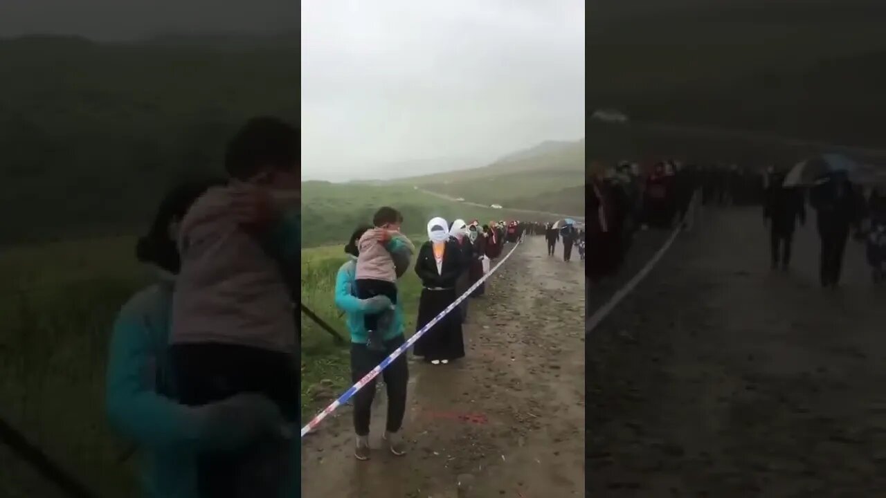 Tibet, Deep in the mountain , authority forcing people lining up in the cold rain to take daily