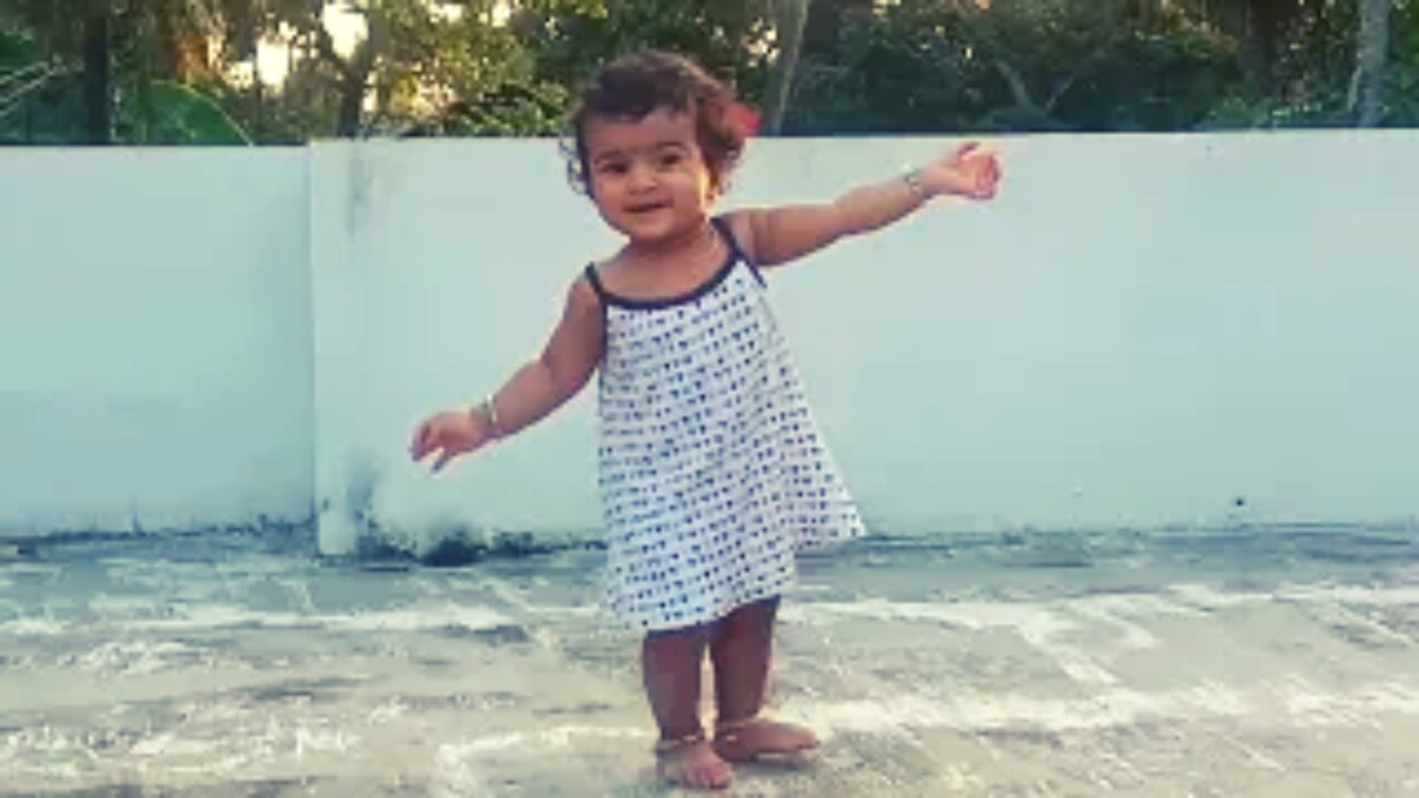 Baby trying to walk in terrace