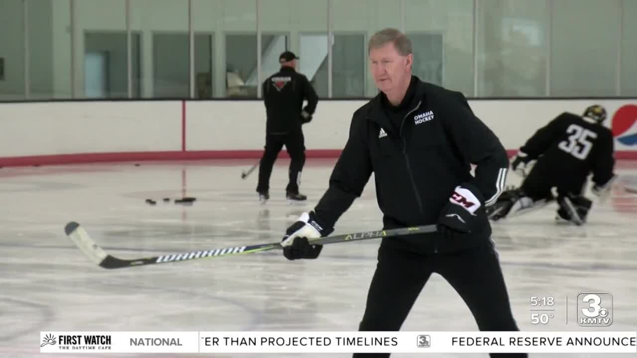 NU President Ted Carter skates with UNO hockey team; he was known as 'Slapshot' in the Navy