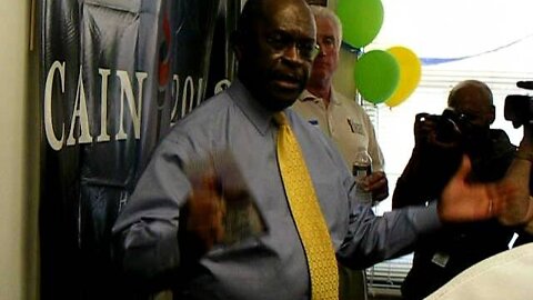 Herman Cain talks to the press and visitors.AVI
