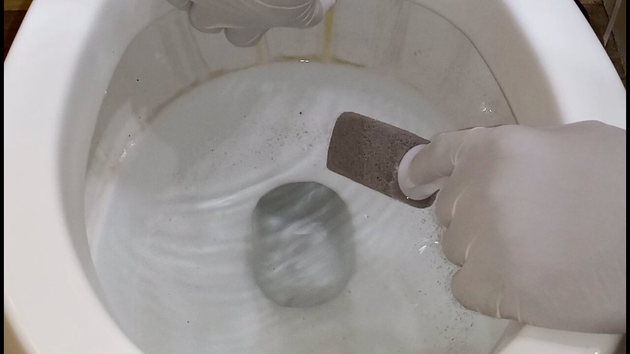 Cleaning A Toilet With A Pumice Stone