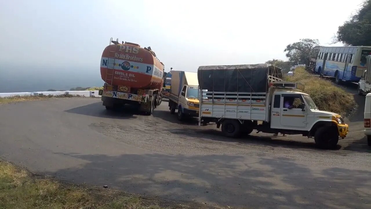 onlineanand:Load Lorry And Govt Bus Turning Dhimbam Hills Driving Hairpin bend Road-01