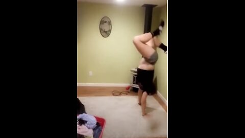 Girl fails headstanding against the wall