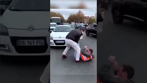 Large angry French man physically removes climate activists from the street