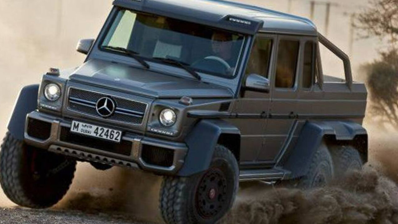 Small and cool. The jeep drives along the sandy beach.