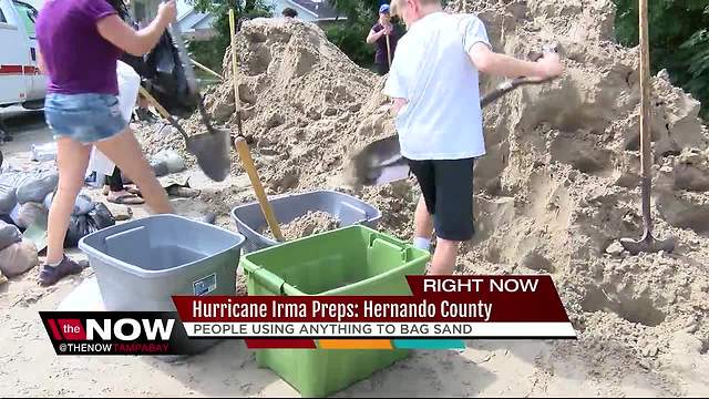 Residents improvise when sandbags run out to protect their homes