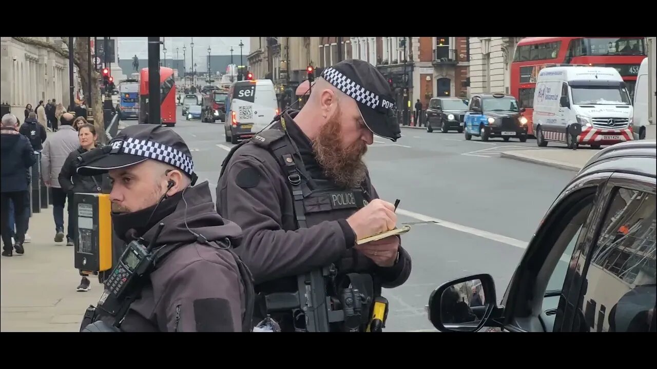 Armed police tell driver to pull over after stopping car to take a photo in the middle of the road.