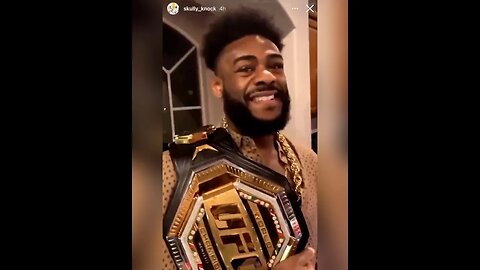 Aljamain Sterling posing with UFC belt after DQ win over Petr Yan