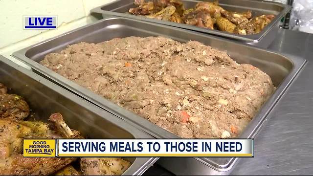 Volunteers from Metropolitan Ministries work to serve meals for those in need