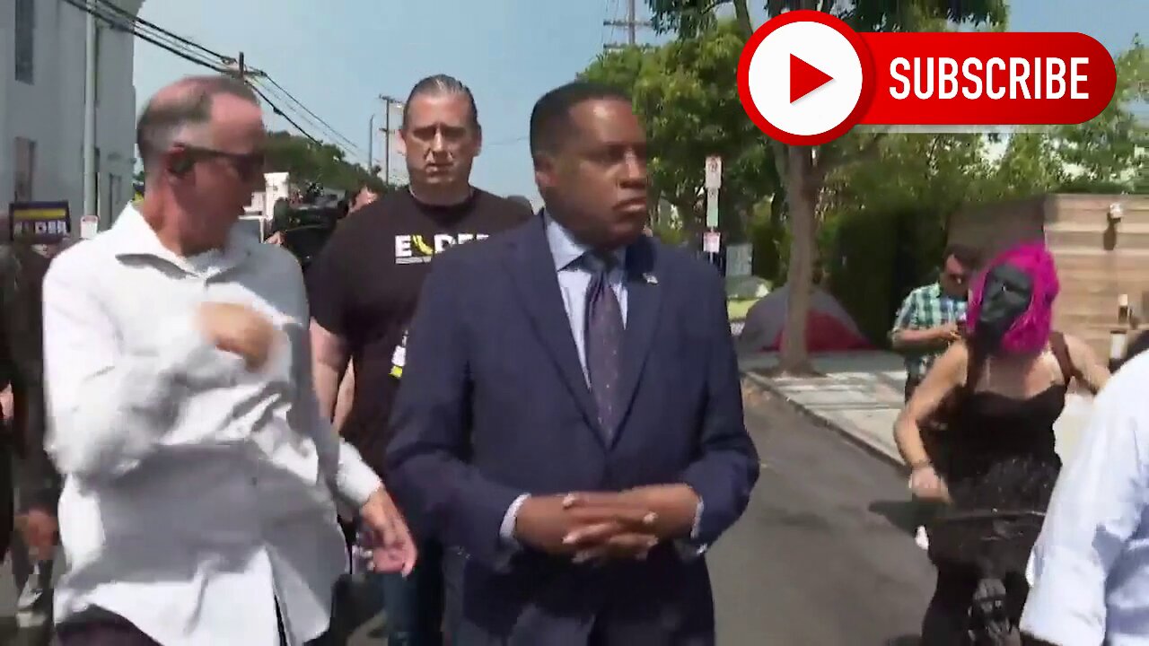 Gavin Newsom Supporters one wearing a monkey mask- throw things at Larry elder in califronia recall