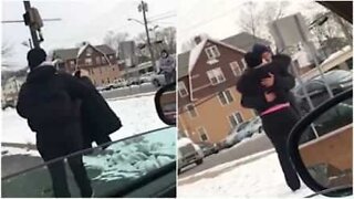 A woman gives a coat to a man in need after spotting him out in the cold