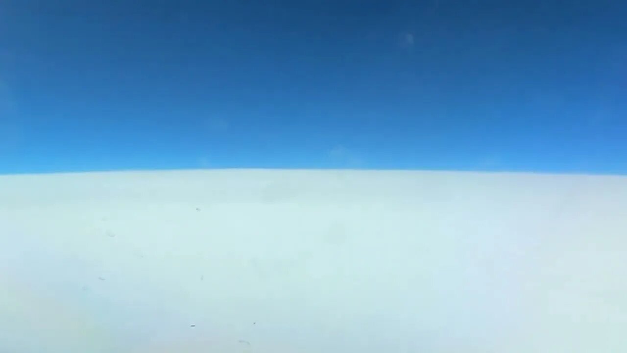 Time lapse video of flying on top of the clouds.