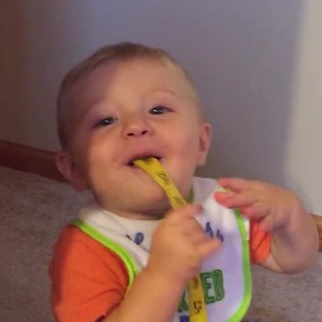 Little Boy Does Magic Trick with Roll of Tape Measurement
