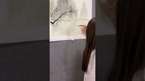 Beautiful Chinese Girl Draws A Tree With A Mountain Background