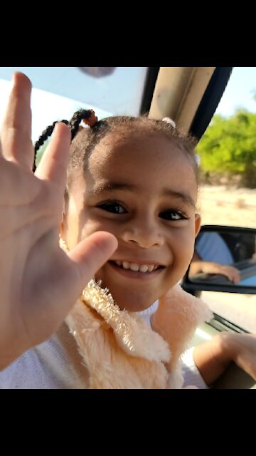 Little Girl Giving Peace laughing And Playing In The Car