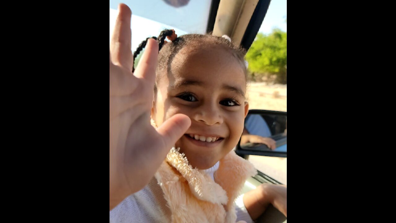 Little Girl Giving Peace laughing And Playing In The Car