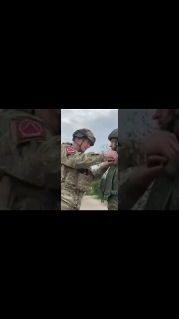 Russian giving our heros badges to the local armed force.