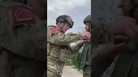 Russian giving our heros badges to the local armed force.