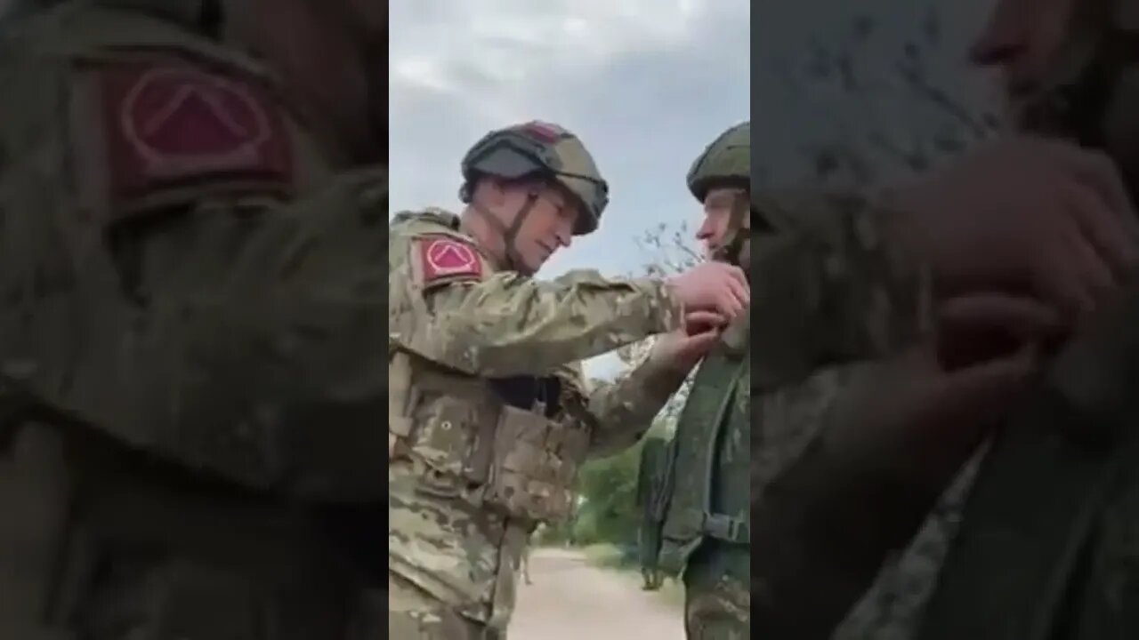 Russian giving our heros badges to the local armed force.