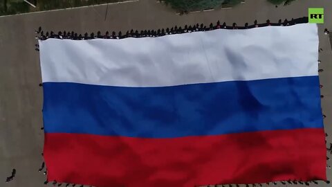 A giant Russian flag was displayed by Mariupol residents for the Day of Russia