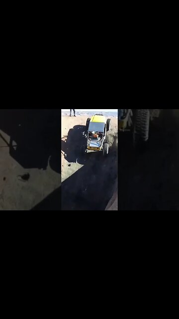 Yellow buggy crawls out of a pothole at the mall