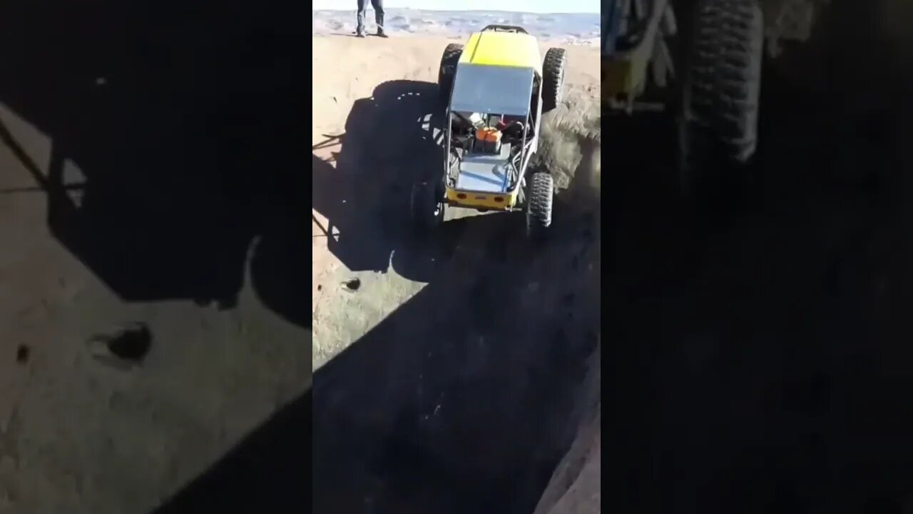 Yellow buggy crawls out of a pothole at the mall