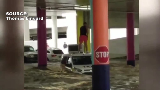 Man stranded on taxi during flooding