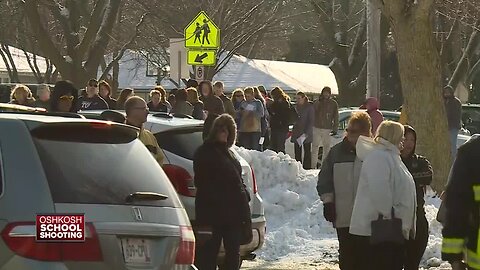 Parents wait in long line to reunite with students after shooting at Oshkosh West High School