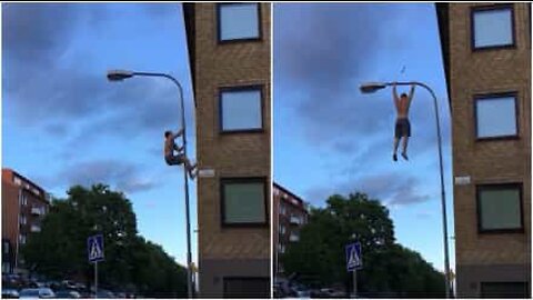 Man works out with a lamp post