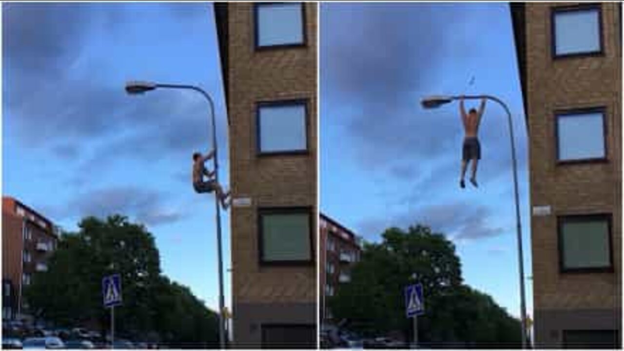 Man works out with a lamp post